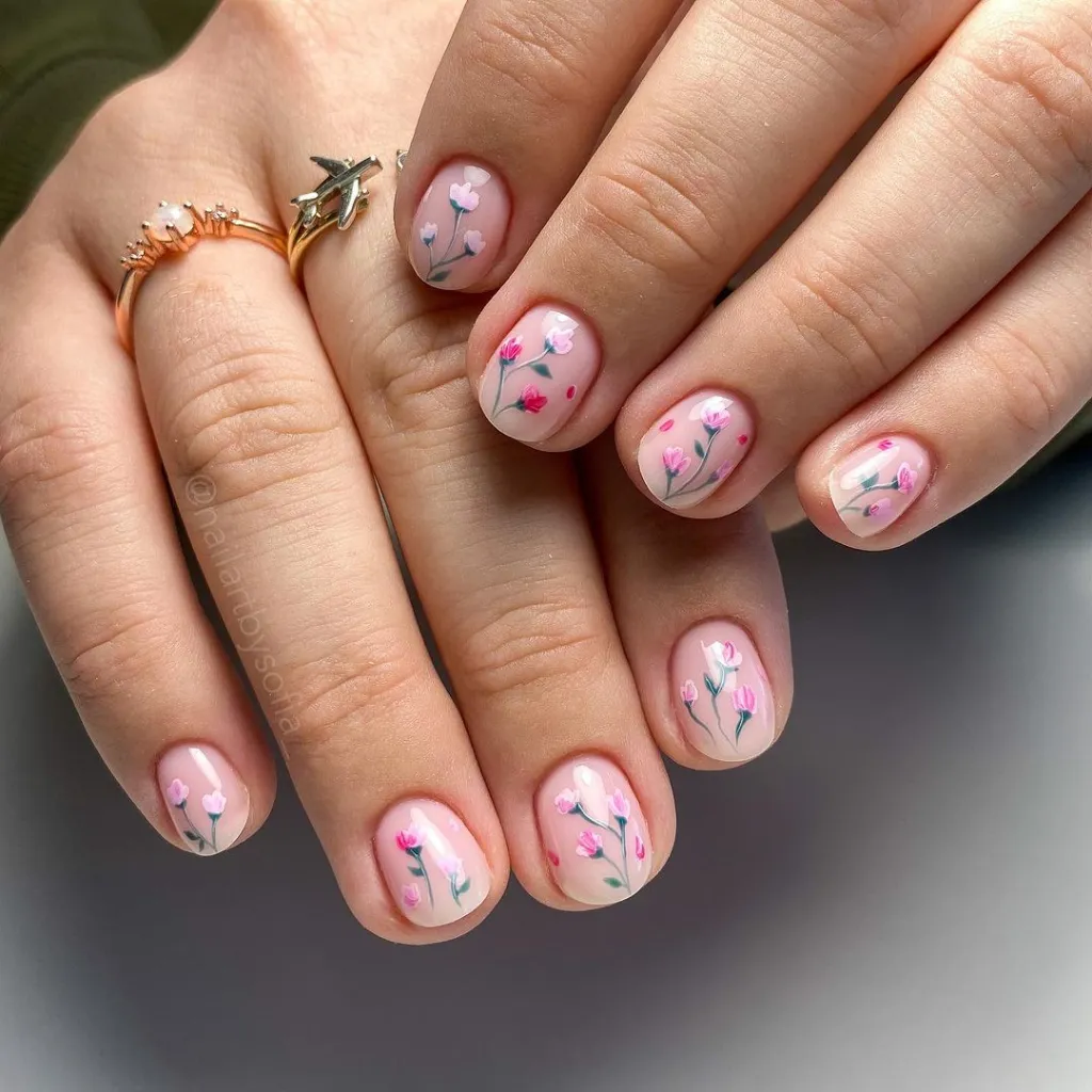 Detailed nail art with floral pattern in blush tones